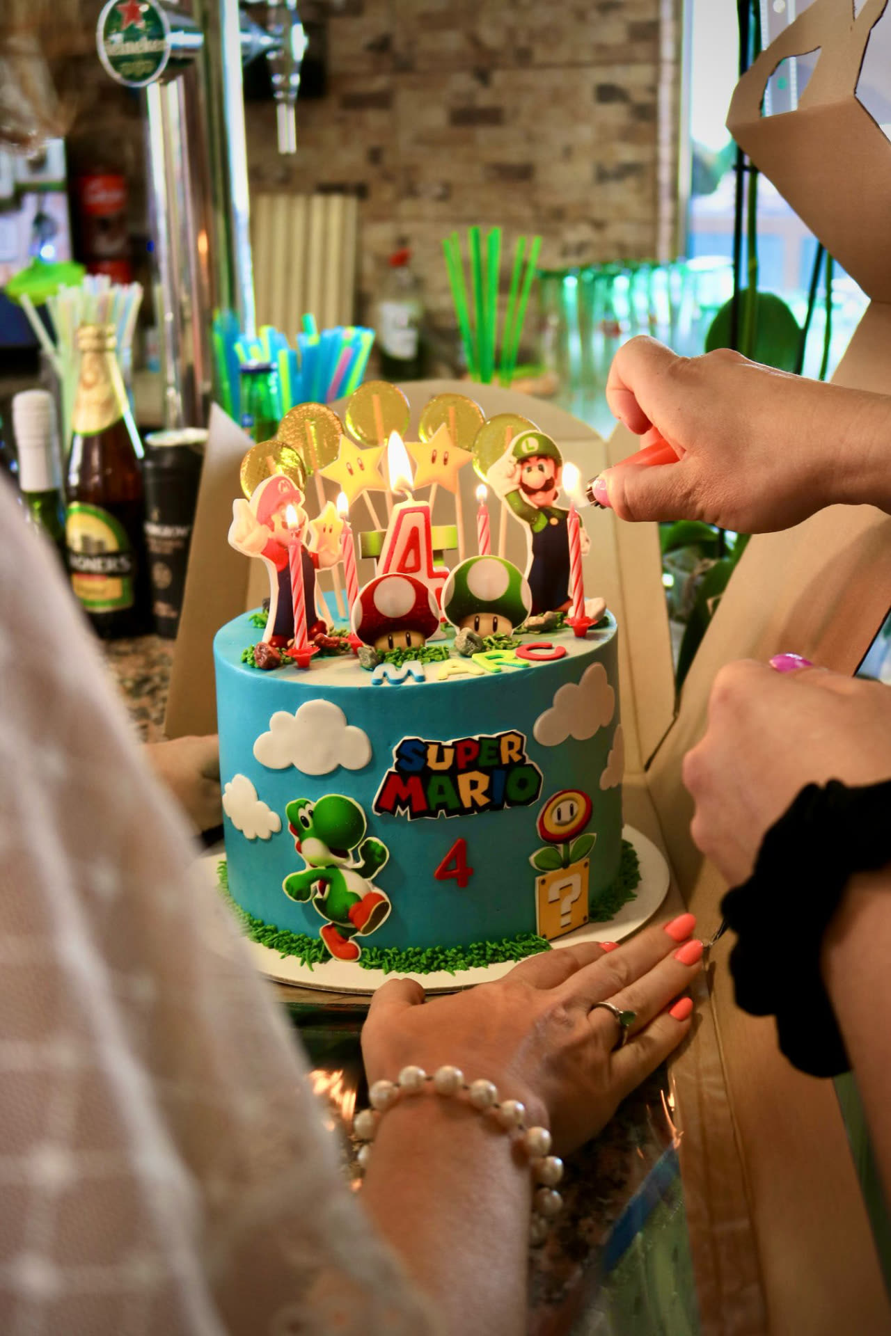 A birthday cake with candles being lit at Dream Park