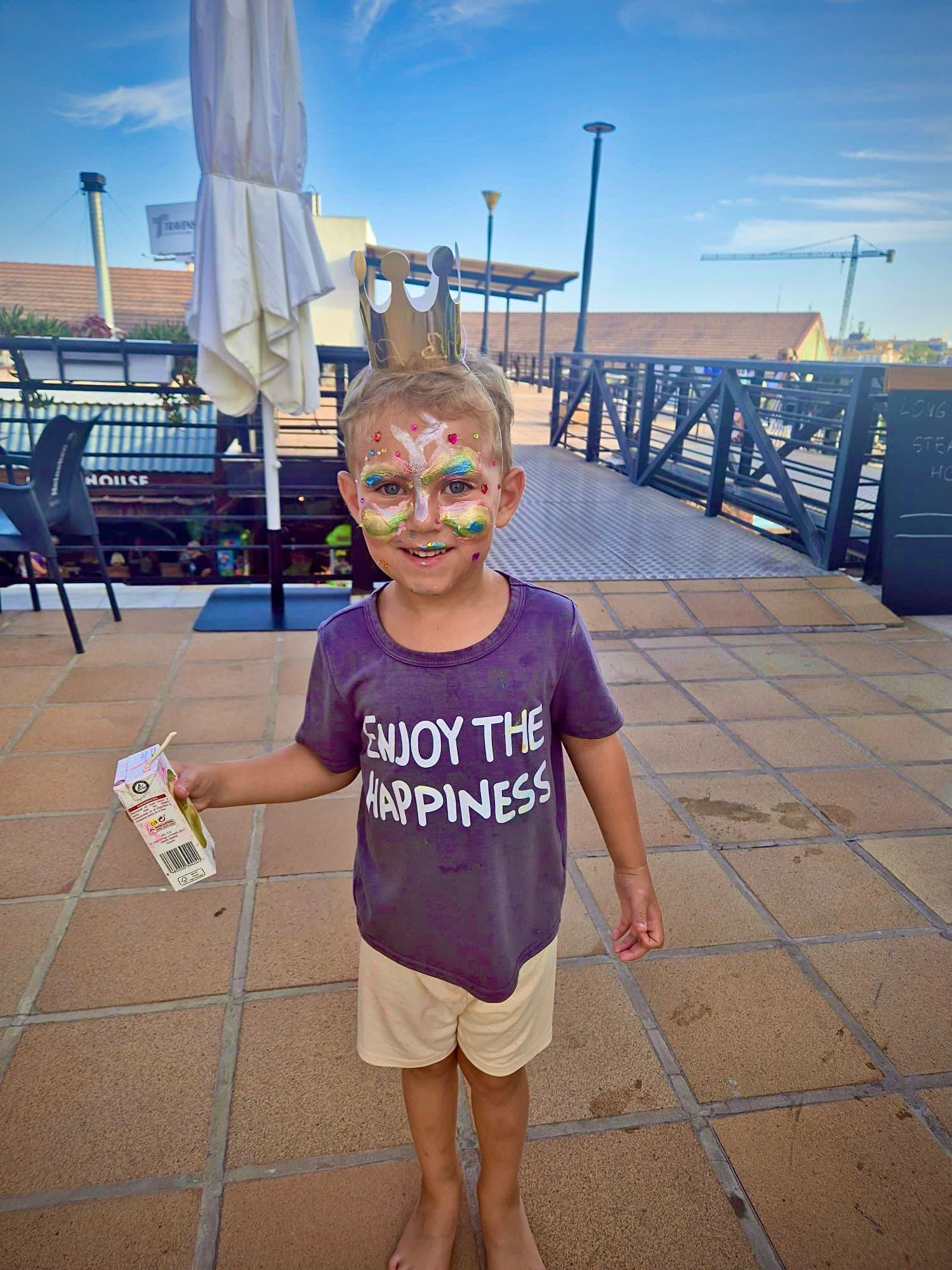 Child with face painting at a Dream Park event