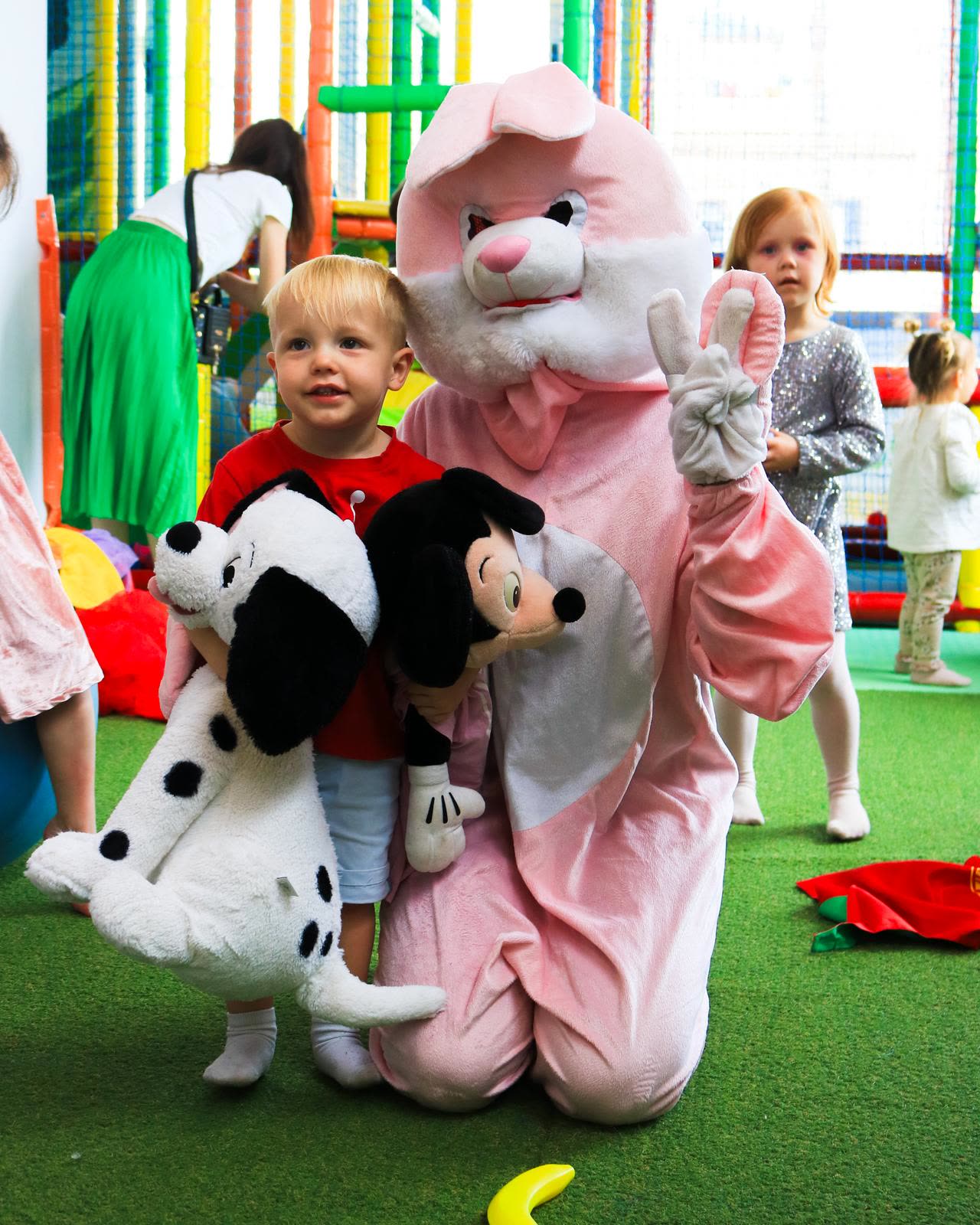 A child meeting a costumed character in the play area at Dream Park