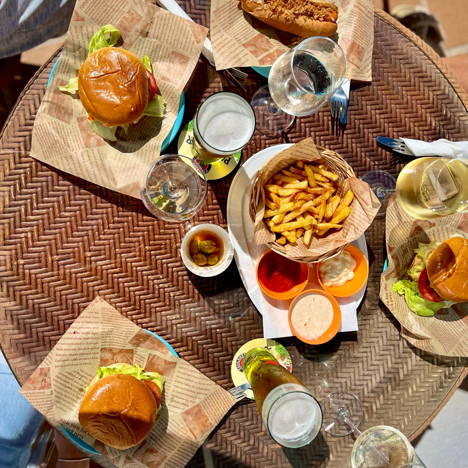 Burgers, chips, dips and drinks on a table at Dream Park