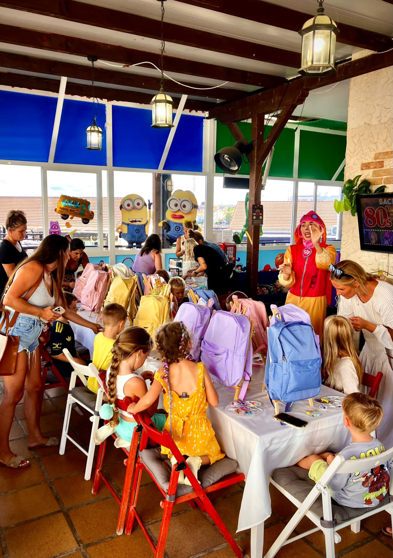 Families enjoying a themed event with a costumed entertainer at Dream Park